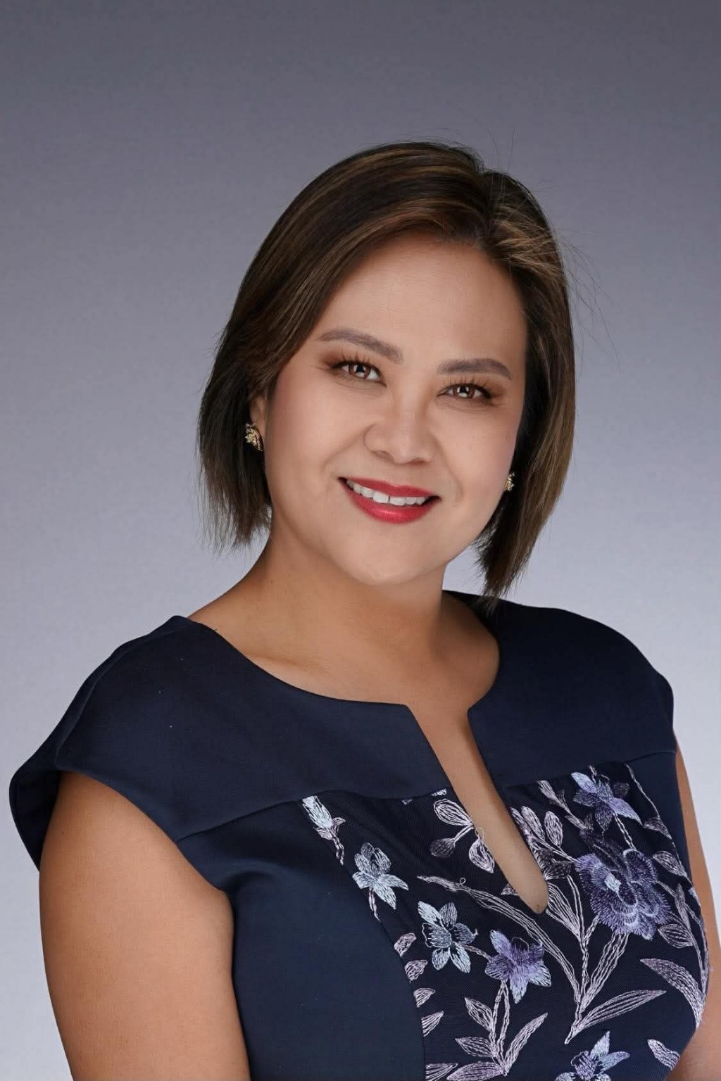 Janice Jimenez in a navy floral dress